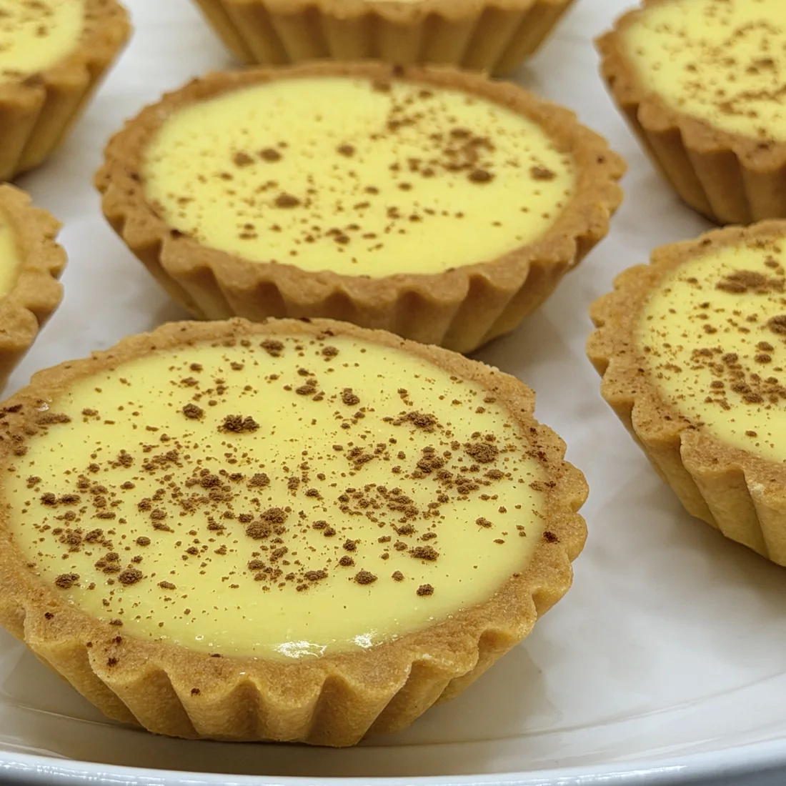 Custard tarts dusted with cinnamon