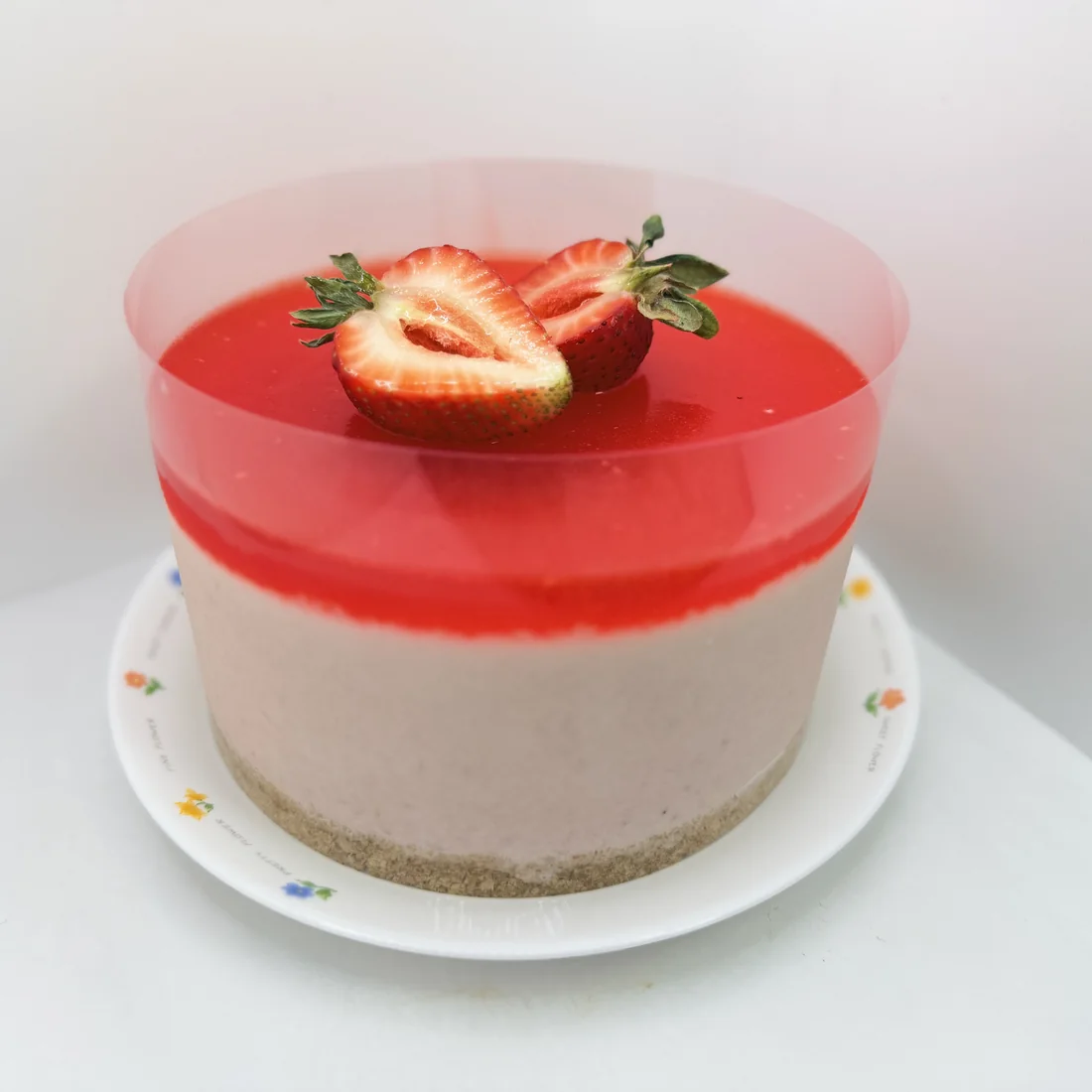 Strawberry mousse cake topped with fresh strawberries